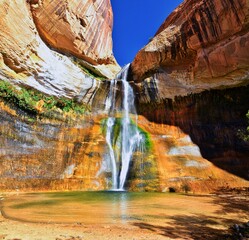 Lower Calf Creek Falls Waterfall colorful views from the hiking trail Grand Staircase Escalante National Monument between Boulder and Escalante in Southern Utah. United States.