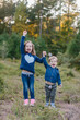 © Jakob Lagerstedt/Stocksy - Cute brother and sister holding hands and laughing