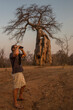 © Diane Durongpisitkul/Stocksy - Binoculars, Baobab, Man