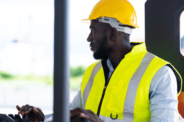 Warehouse man worker driver forklift. warehouse worker driver stacking card boxes by forklift in warehouse store. African American black people.