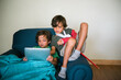 © Tara Romasanta Photography/Stocksy - brothers looking at a tablet device