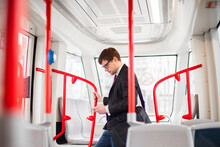 Young Businessman Traveling In Public Transport.