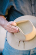© Gillian Vann/Stocksy - retired farmer holding his bush hat