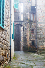 Canvas Print - Alley between buildings in a city