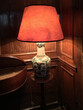 © Phillips Visuals/Stocksy - Table lamp standing in the corner of a period room.