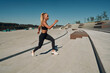 © Alexandr - A young woman athlete runs on concrete steps. A blonde in a black suit is engaged at dawn. Healthy lifestyle. Motivation
