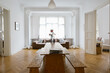 © VISUALSPECTRUM/Stocksy - Large Table in Bright Stylish City Apartment Living Room