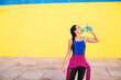 © BONNINSTUDIO/Stocksy - Woman wearing a wetsuit drinking water after workout.