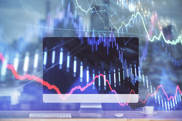 Stock market graph on background with desk and personal computer. Multi exposure. Concept of financial analysis.