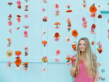 Blonde Girl With Flower Wall With Pink Flowers