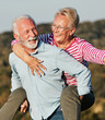 © Lumos sp - woman man outdoor senior couple happy lifestyle retirement together smiling love piggyback active mature