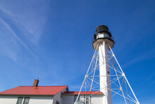 Whitefish Point Lighthouse Stands Guard On The Isolated Lake Superior Shoreline. In The Upper Peninsula Of Michigan.

