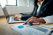 © David - Financial Businesswomen analyze the graph of the company's performance to create profits and growth, Market research reports and income statistics, Financial and Accounting concept.