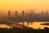 Fototapeta  - Patona bridge at the golden dawn, Kiev, Ukraine. Left bank of the city, Dnipro river