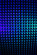Abstract pyramid background in colored light. Sound insulation material Blue colour