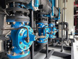 Pump rooms, pipes and valves in large industrial pumping stations