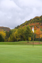 White Golf Flag With Autumn Colors In The Mountains