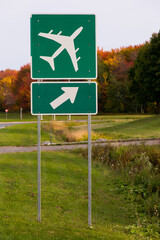 Vertical view of roadside airport sign with fall foliage in the background, Quebec City, Quebec, Canada