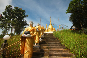 Buddha statue on the stairs is a Burmese art Located in a temple on the mountain of Thai and Myanmar border at Kanchanaburi Province, Thailand