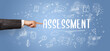 © ra2 studio - Close-Up of cropped hand pointing at ASSESSMENT inscription, modern business solution concept