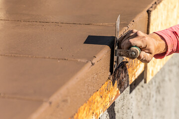 Wall Mural - Construction Worker Using Stainless Steel Edger On Wet Cement Forming Coping Around New Pool