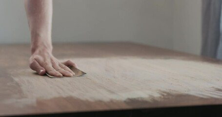 Poster - Slow motion slide orbit shot of man hand sanding black walnut wood table