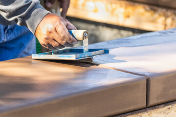 Wall Mural - Construction Worker Using Hand Groover On Wet Cement Forming Coping Around New Pool