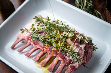 Wall Mural - tied and marinated lamb rack with herbs for roast