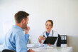 © baranq - Doctor explaining with digital tablet to patient during appointment