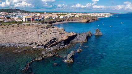 Aerial view of the Cap d'Agde sea resort on the South of France along the Mediterranean Sea - Rocky cape from above