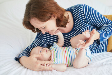 Wall Mural - Young mother bonding with her adorable daughter