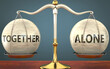 © GoodIdeas - together and alone staying in balance - pictured as a metal scale with weights and labels together and alone to symbolize balance and symmetry of those concepts, 3d illustration