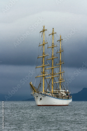 at the anchorage a sailboat or other vessel is waiting out stormy weather © vasilevich