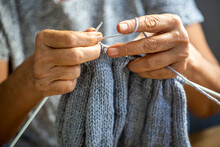 Old Woman's Hands Are Knitting