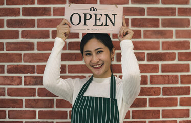 Young Asian woman holding an open sign