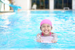 © kornnphoto - Asian child cute or kid girl wear swimming suit on swimming pool and smile with happy fun in water park for learn and training swim on kick board or refreshing and relax to exercise on summer holiday