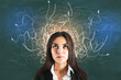 © Who is Danny - Businesswoman in suit with drawing arrows over her head on blackboard.