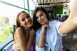 © F8  \ Suport Ukraine - Two young beautiful women sitting in urban cafe and making selfie.