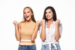 © F8  \ Suport Ukraine - Two happy young women posing standing clenching fists doing winner gesture keeping eyes closed isolated on white background