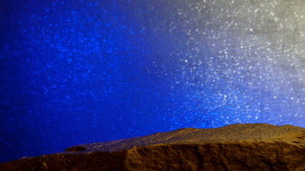 A Gold Tone Rock, Showing Middle Focus to the Metallic Stone, with a Circular Bokeh Background.