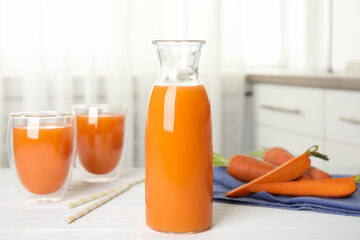 Wall Mural - Freshly made carrot juice on white table