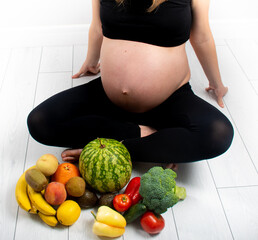 Wall Mural - Pregnant woman with fruit and vegetables around her.