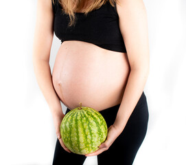 Wall Mural - Pregnant woman holding watermelon in her hands. Healthy lifestyle dieting