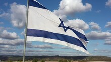 Large National Flag Of Israel Waving In The Wind, Aerial View.
