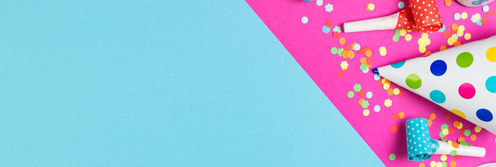 Birthday party background on blue and pink color. Party accessories on multicolored