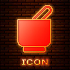 Sticker - Glowing neon Mortar and pestle icon isolated on brick wall background. Vector.