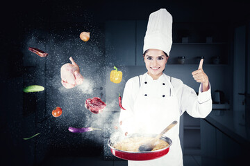 Female chef show thumb up while cooking in kitchen