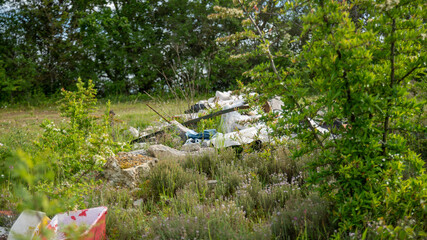 Outdoor landfill of waste, in full vegetation	