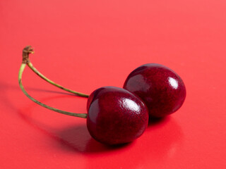 bright juicy ripe cherry berry isolated on a red background