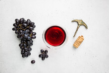 Red Wine In A Glass And Ripe Grapes On White Background, Top View